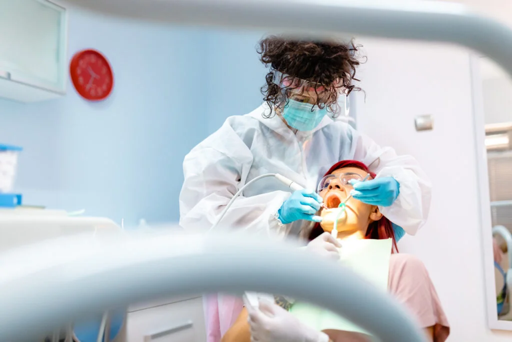 Periodontist removes hard and soft deposits from the enamel so the patient can have a beautiful smile